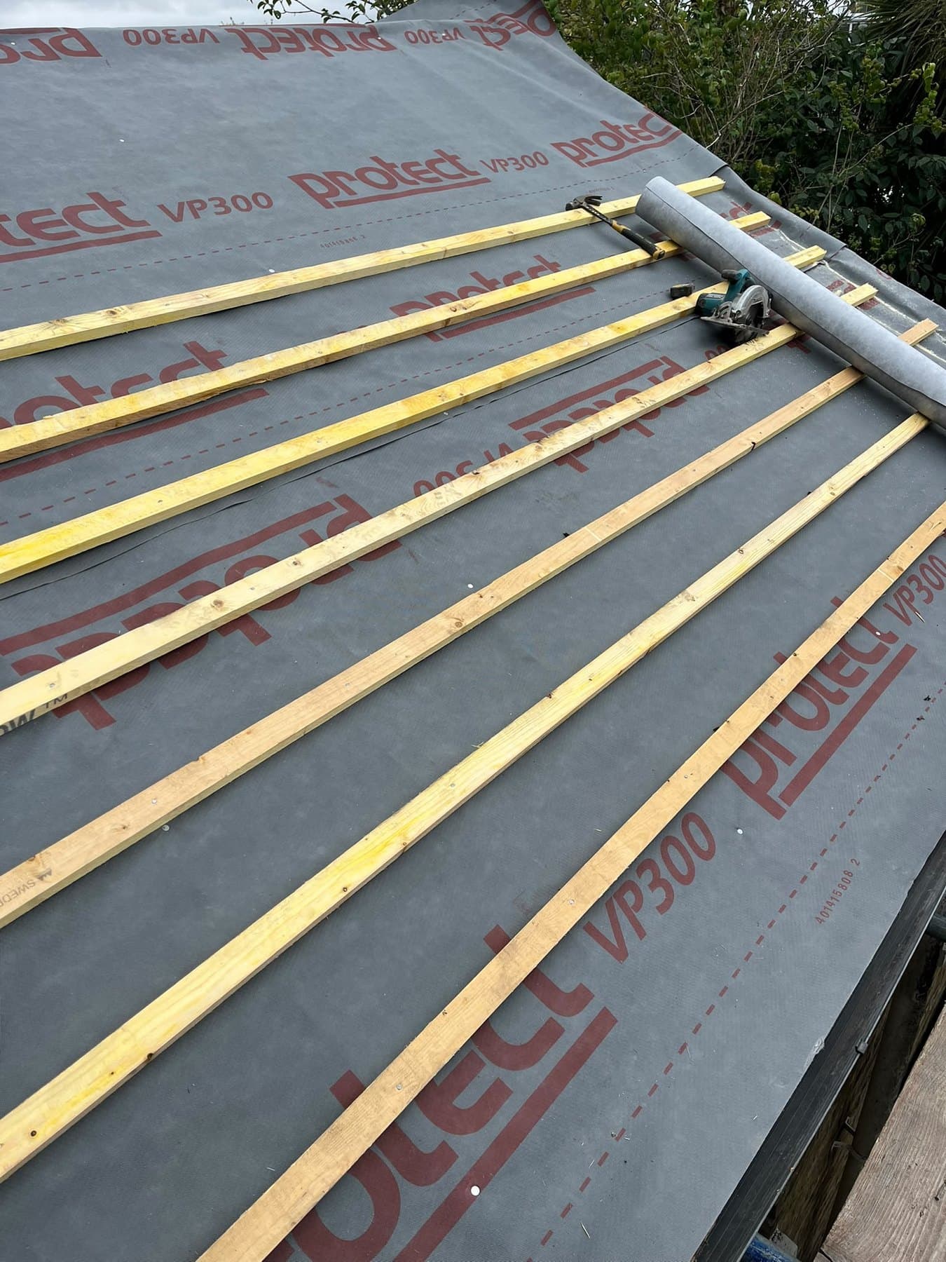 Battening under way with a saw and hammer to hand