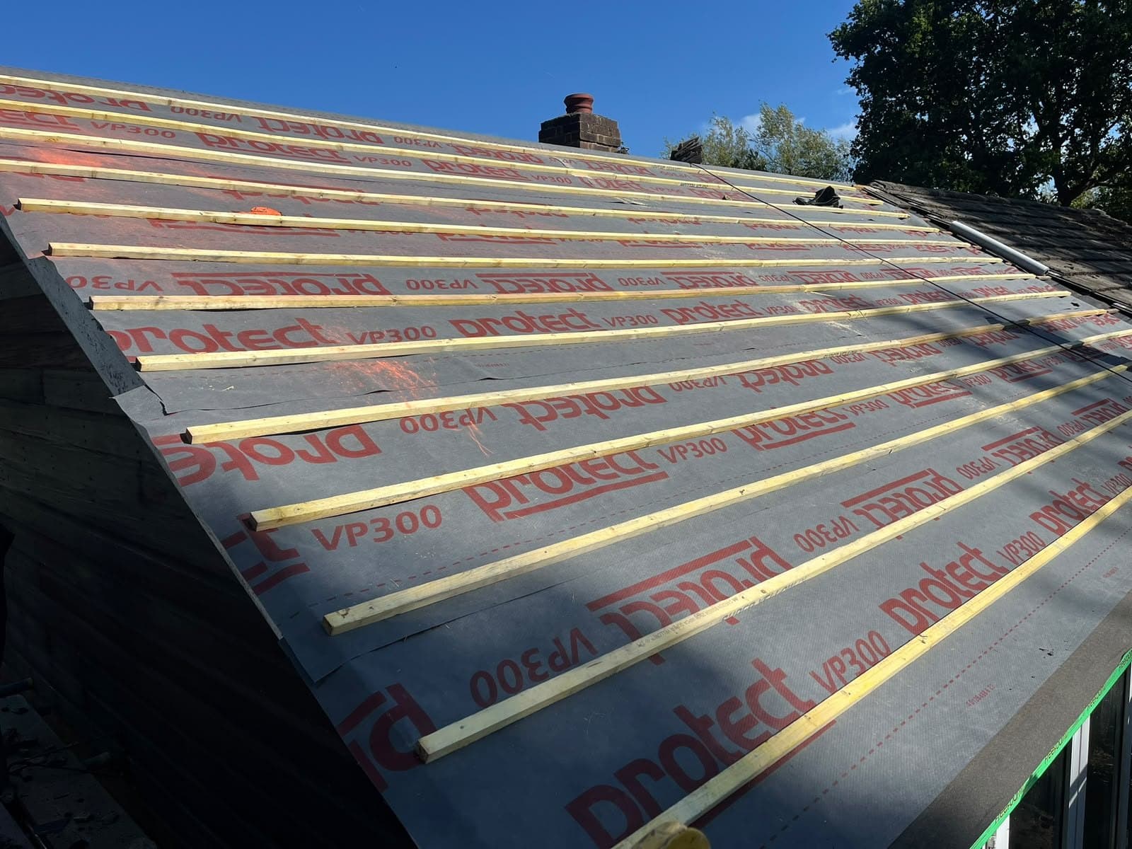 New membrane and battens, chimney beyond