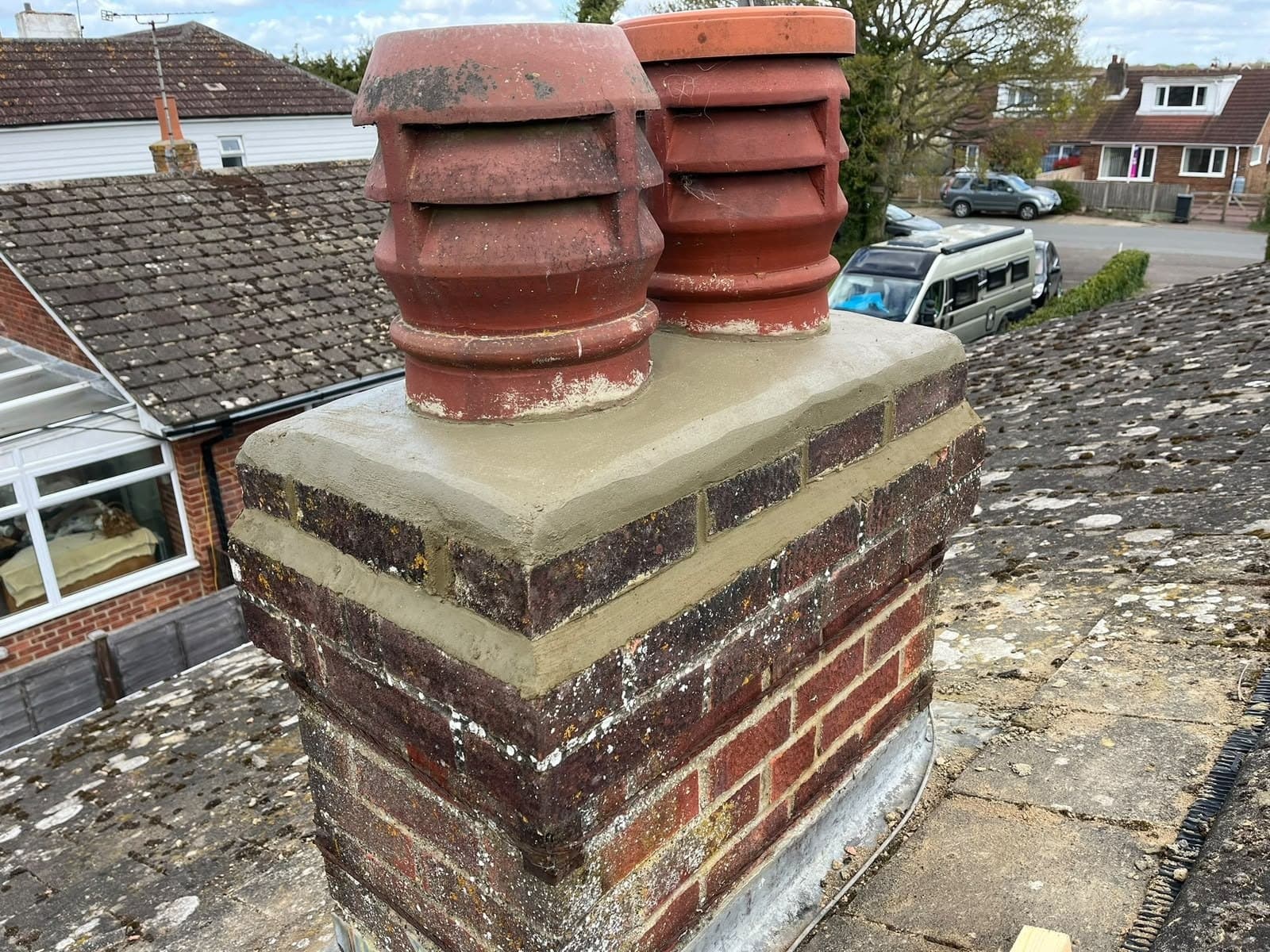 Chimney rebuilt with a rendered cap and its pots refitted