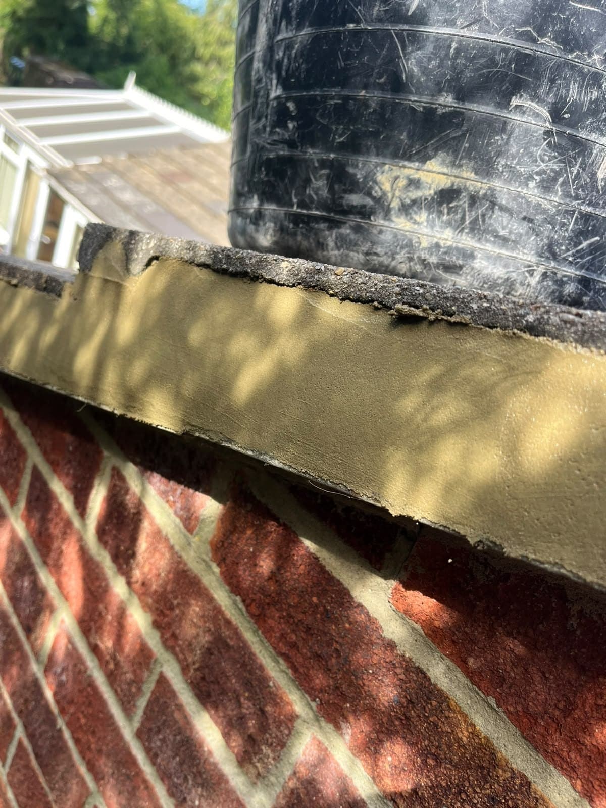 Lead flashing dressed against brickwork