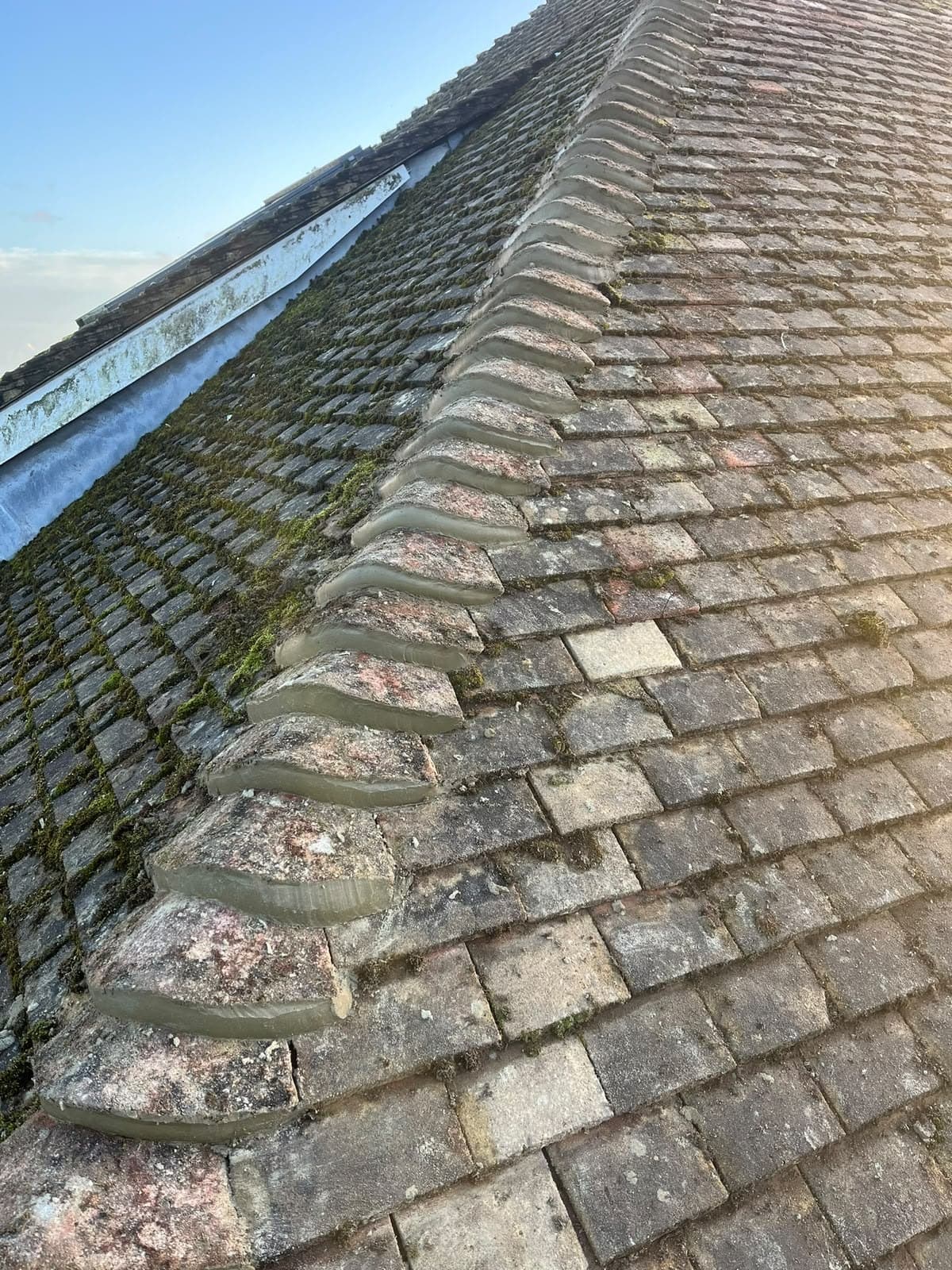 Ridge tiles bedded along the roof