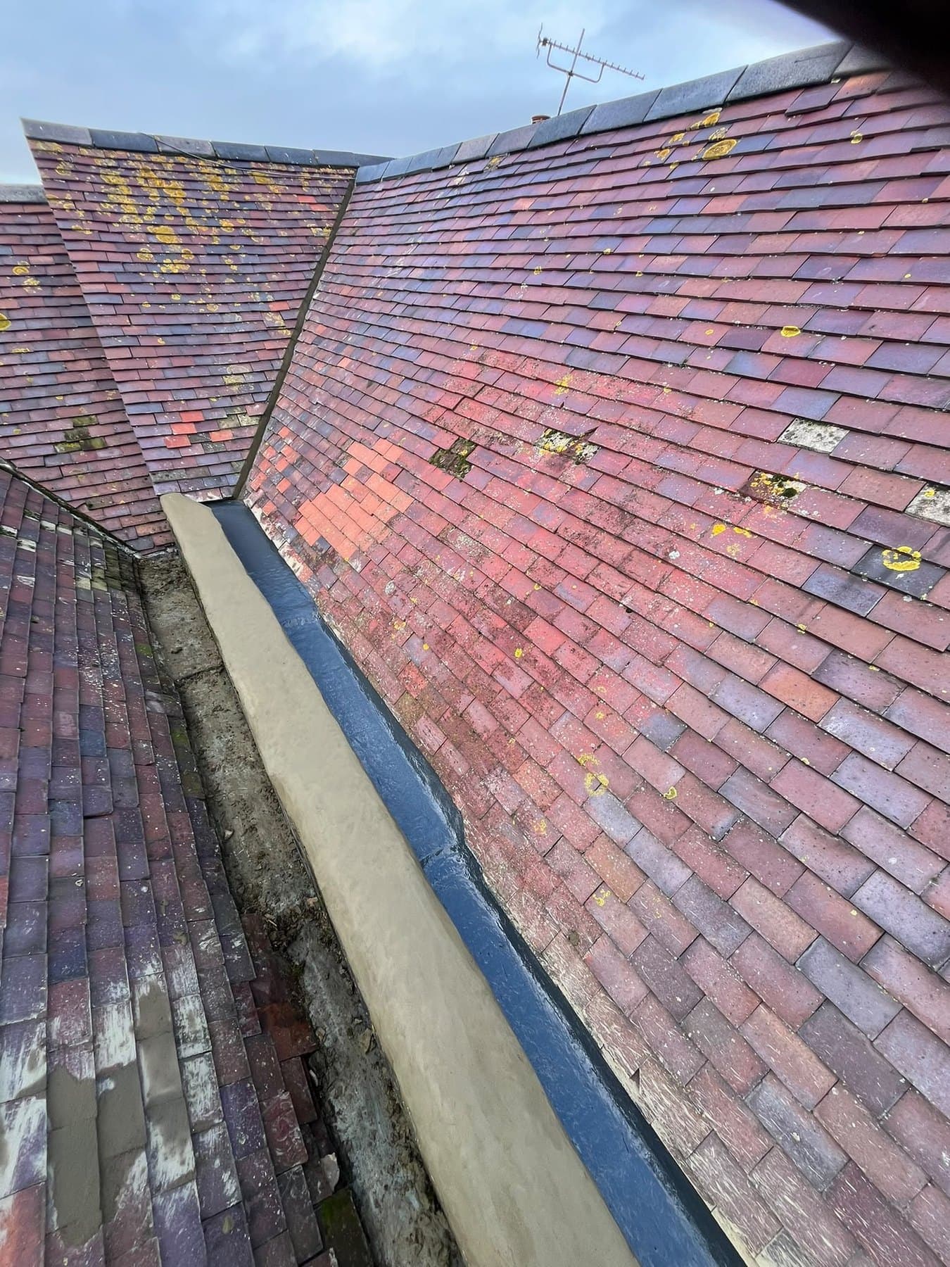 Lined valley gutter running beside a tiled slope